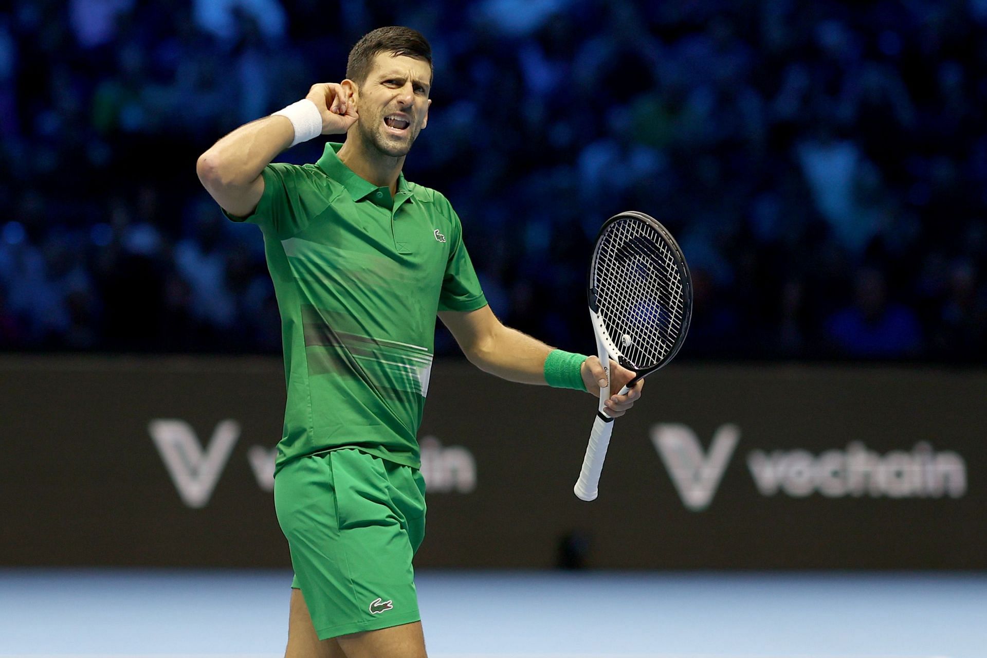 Novak Djokovic gestures to the crowd during his match against Stefanos Tsitsipas at the 2022 ATP Finals.