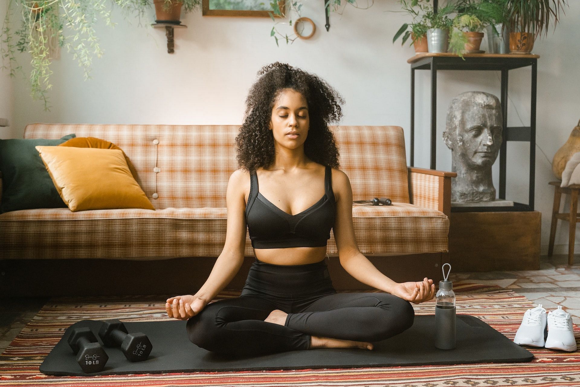 An evening yoga routine helps relax the mind. (Photo via Pexels/MART PRODUCTION)