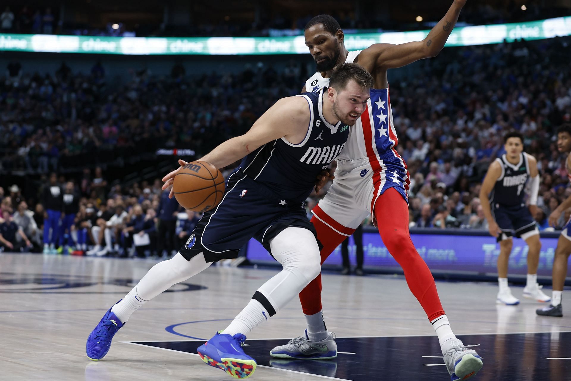Luka Doncic of the Dallas Mavericks drives to the basket against Kevin Durant of the Brooklyn Nets