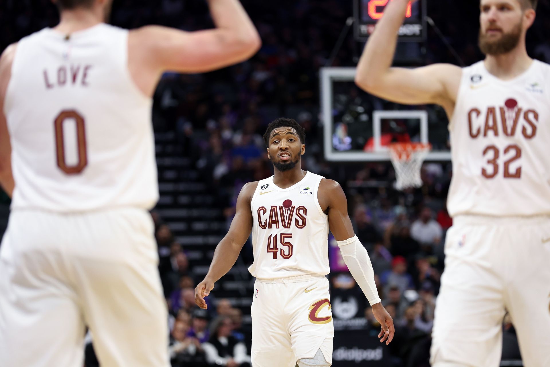 Donovan Mitchell of the Cleveland Cavaliers talks to Kevin Love and Dean Wade