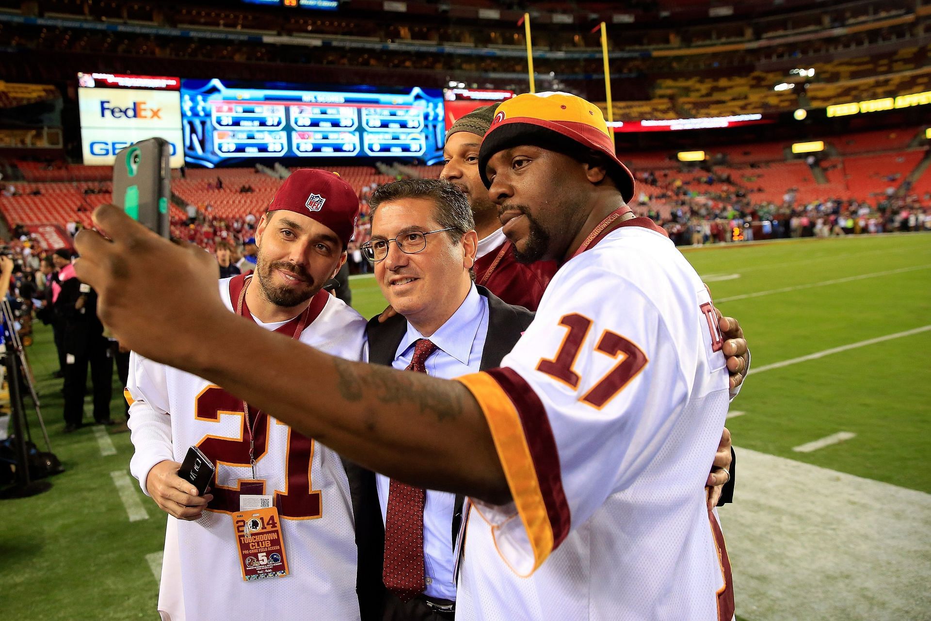 Dan Snyder posing with fans before a game against the Seattle Seahawks 