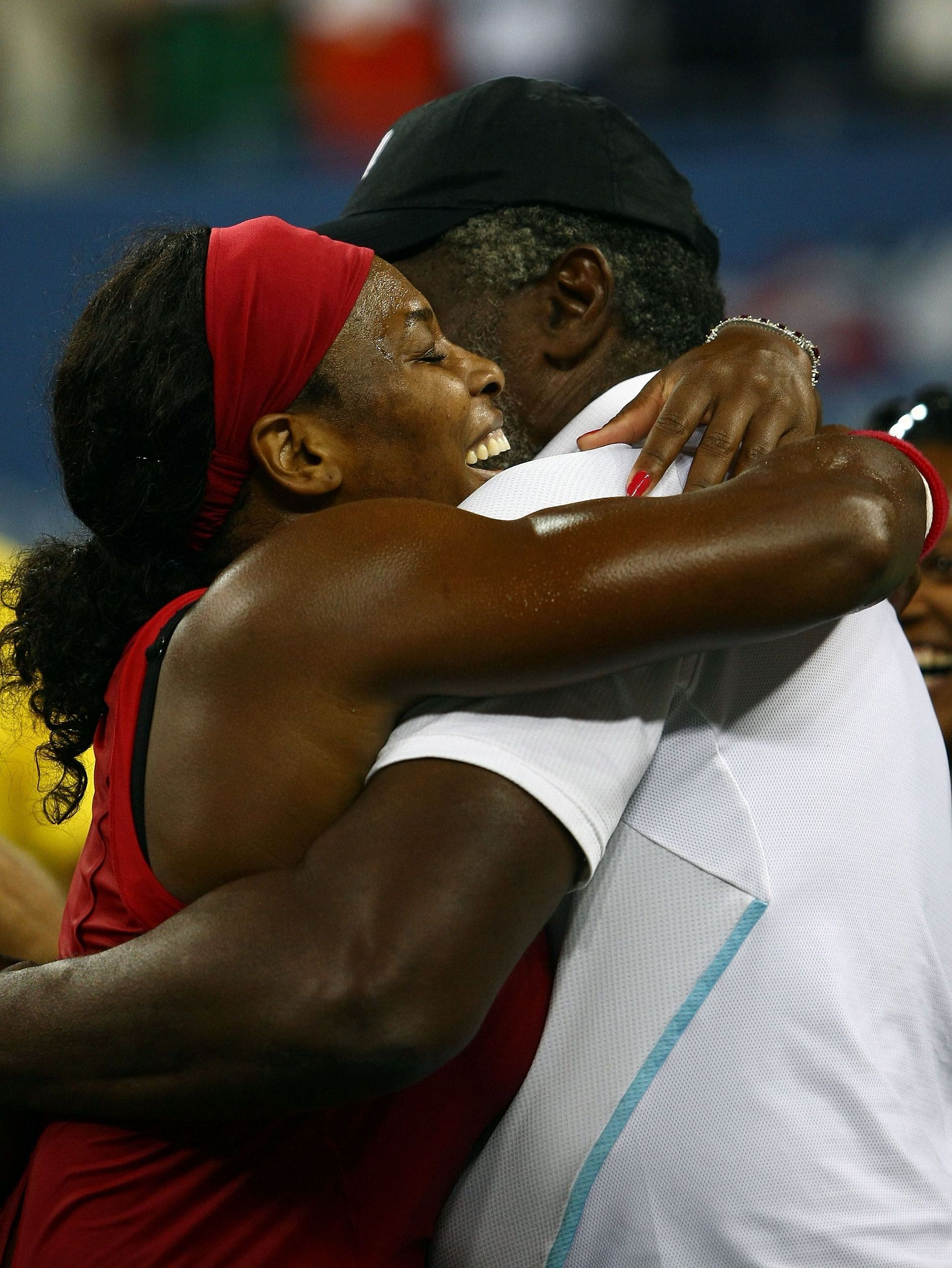 Father and daughter share a hug after Serena Williams won the 2008 US Open.