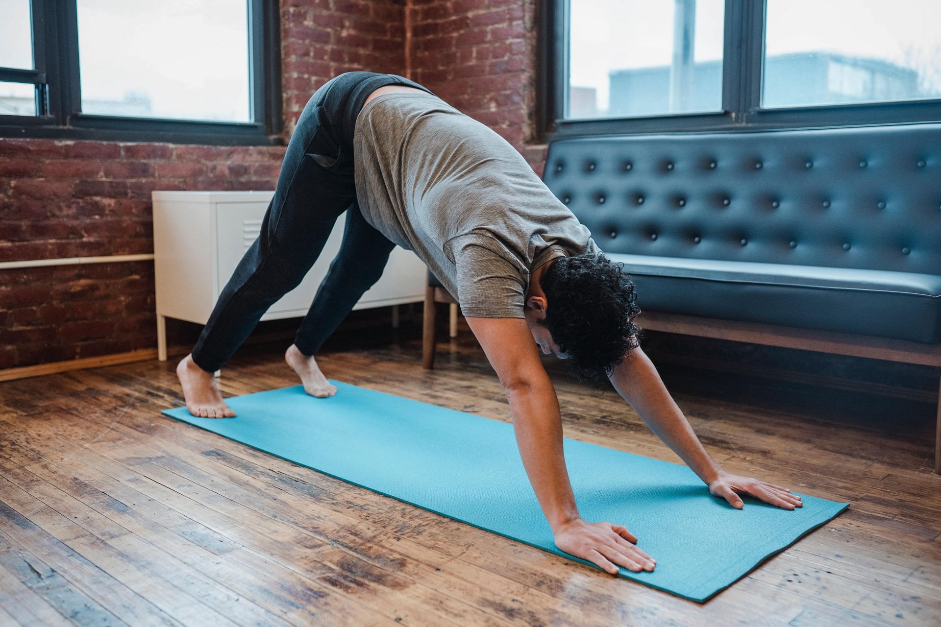 Downward facing dog pose is one of the best exercises to relieve tired legs (Image via Pexels @Klaus Nielsen)
