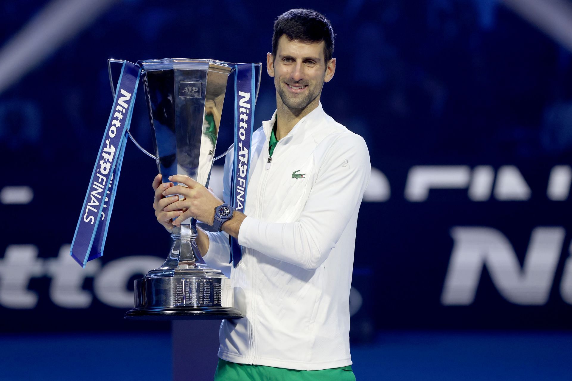 Novak Djokovic poses with his ATP Finals trophy.