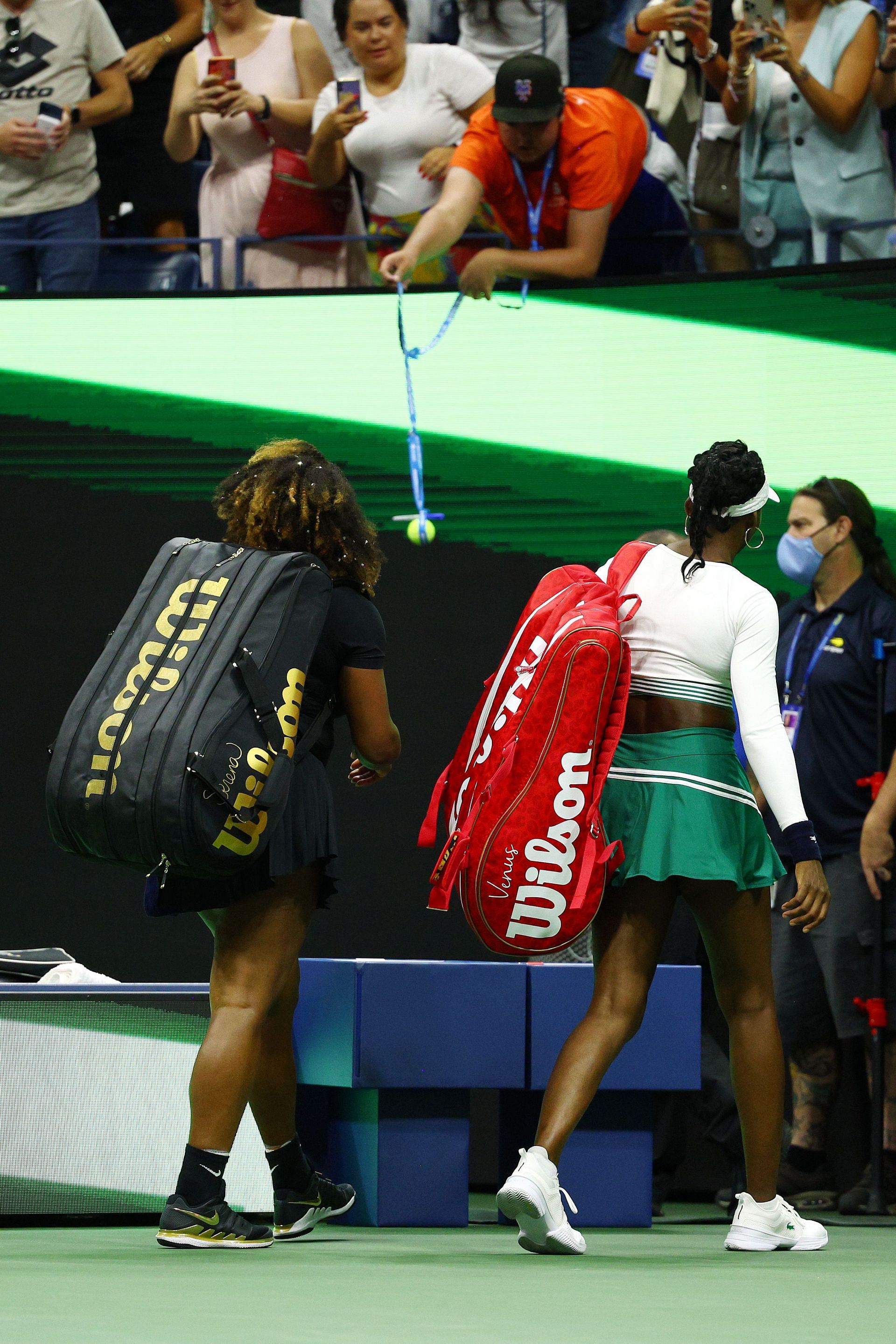 Venus Williams and Serena Williams leave the court following defeat at the 2022 US Open.