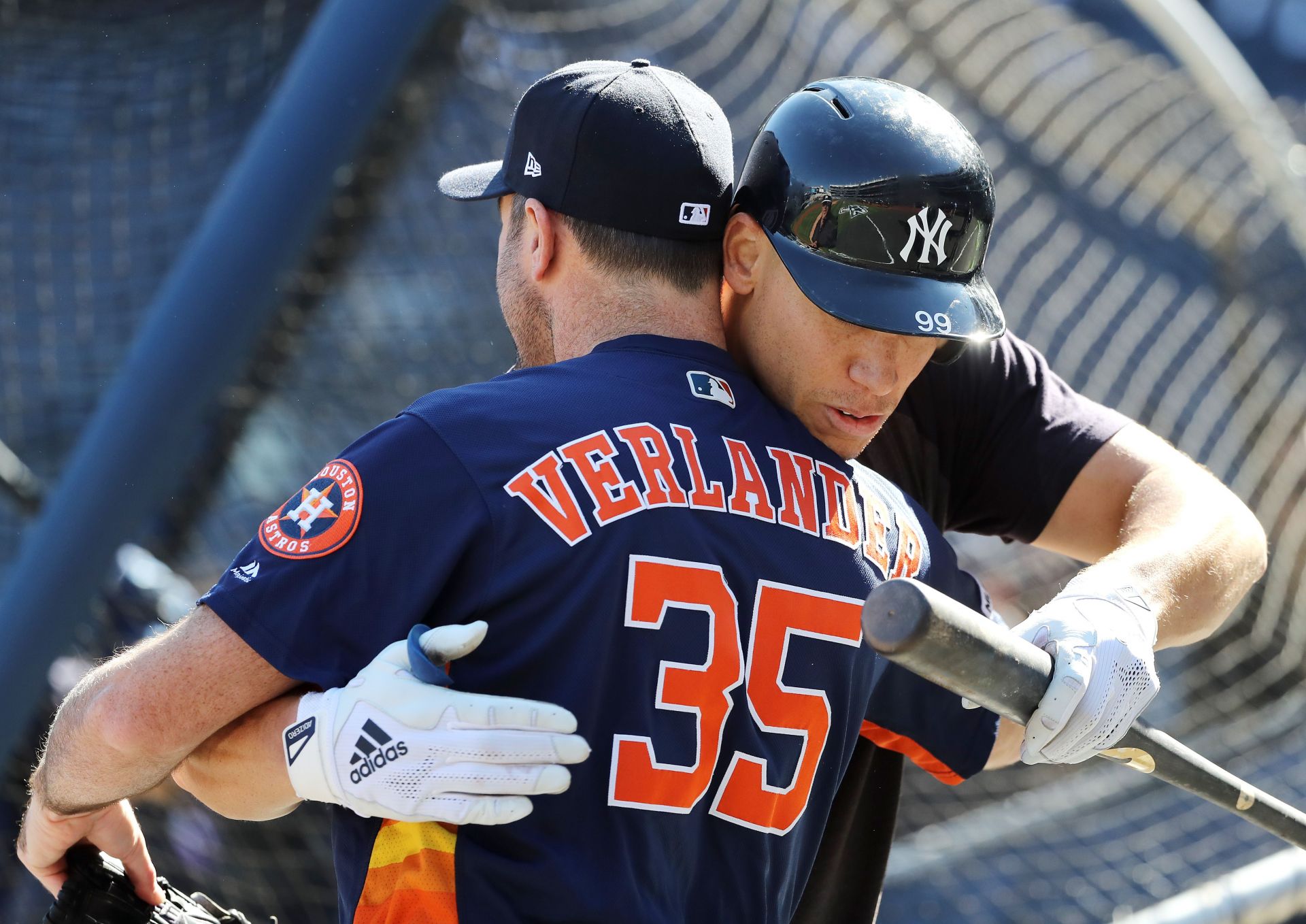 Aaron Judge #99 of the New York Yankees hugs Justin Verlander #35 of the Houston Astros during batting practice