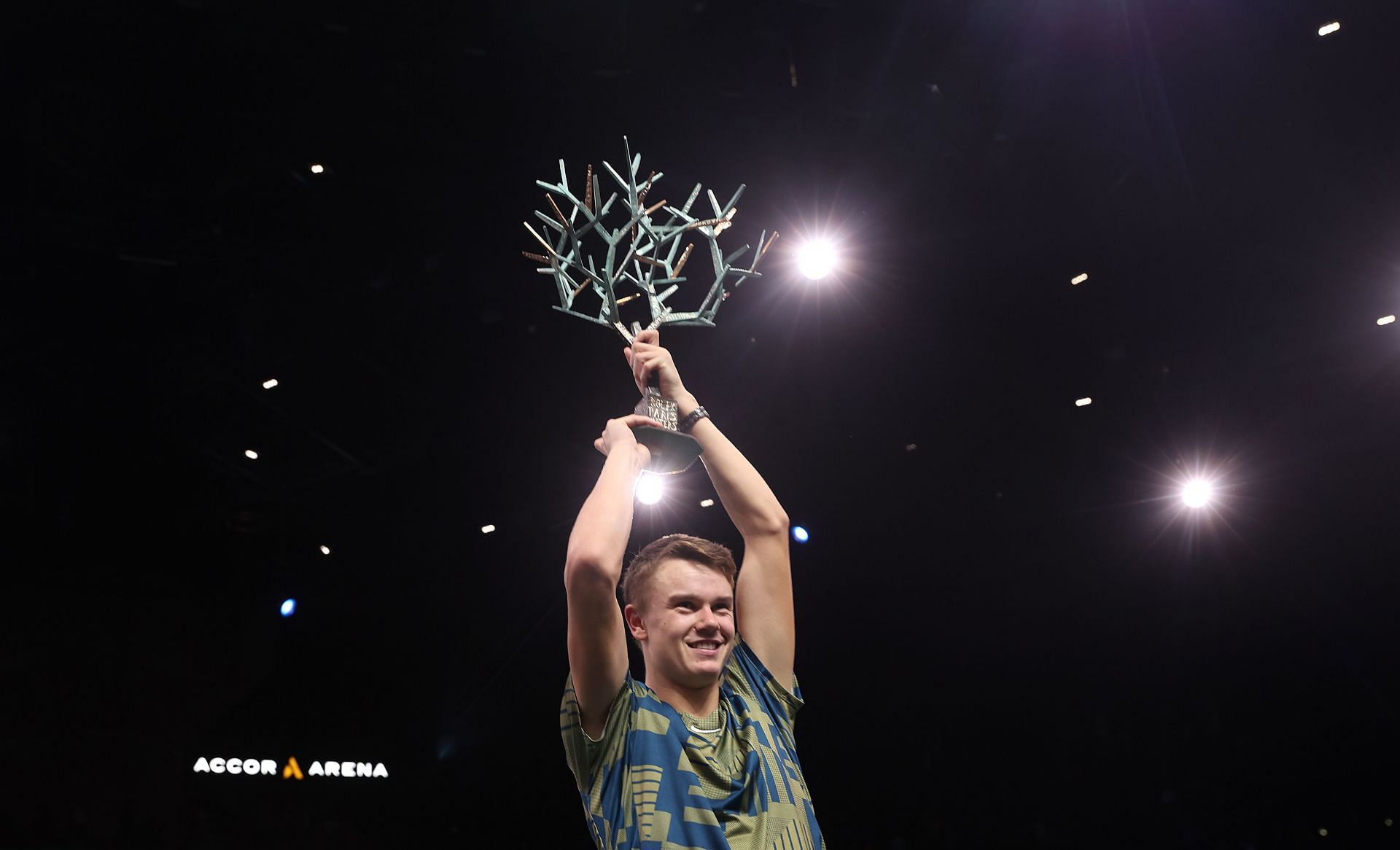 Holger Rune celebrates with the winner&#039;s trophy after defeating Novak Djokovic in the final at the Rolex Paris Masters 