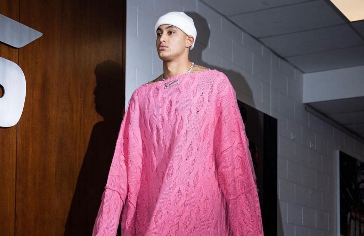 Kyle Kuzma arriving for a game wearing an oversized pink sweater