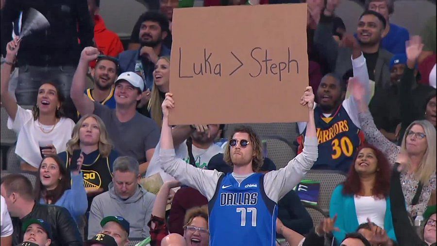 A Dallas Mavericks fan holding up a controversial &ldquo;Luka&gt;Steph&rdquo; sign at a recent Mavericks versus Warriors game