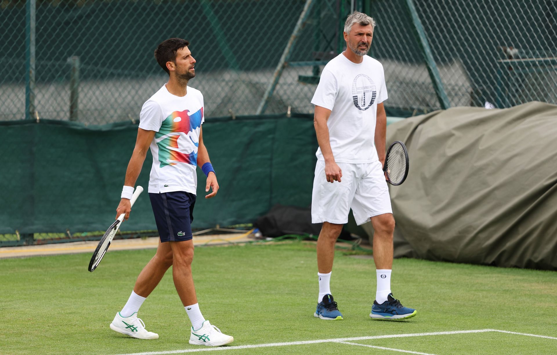 Novak Djokovic (L of Serbia looks on with Coach, Goran Ivanisevic during their training session