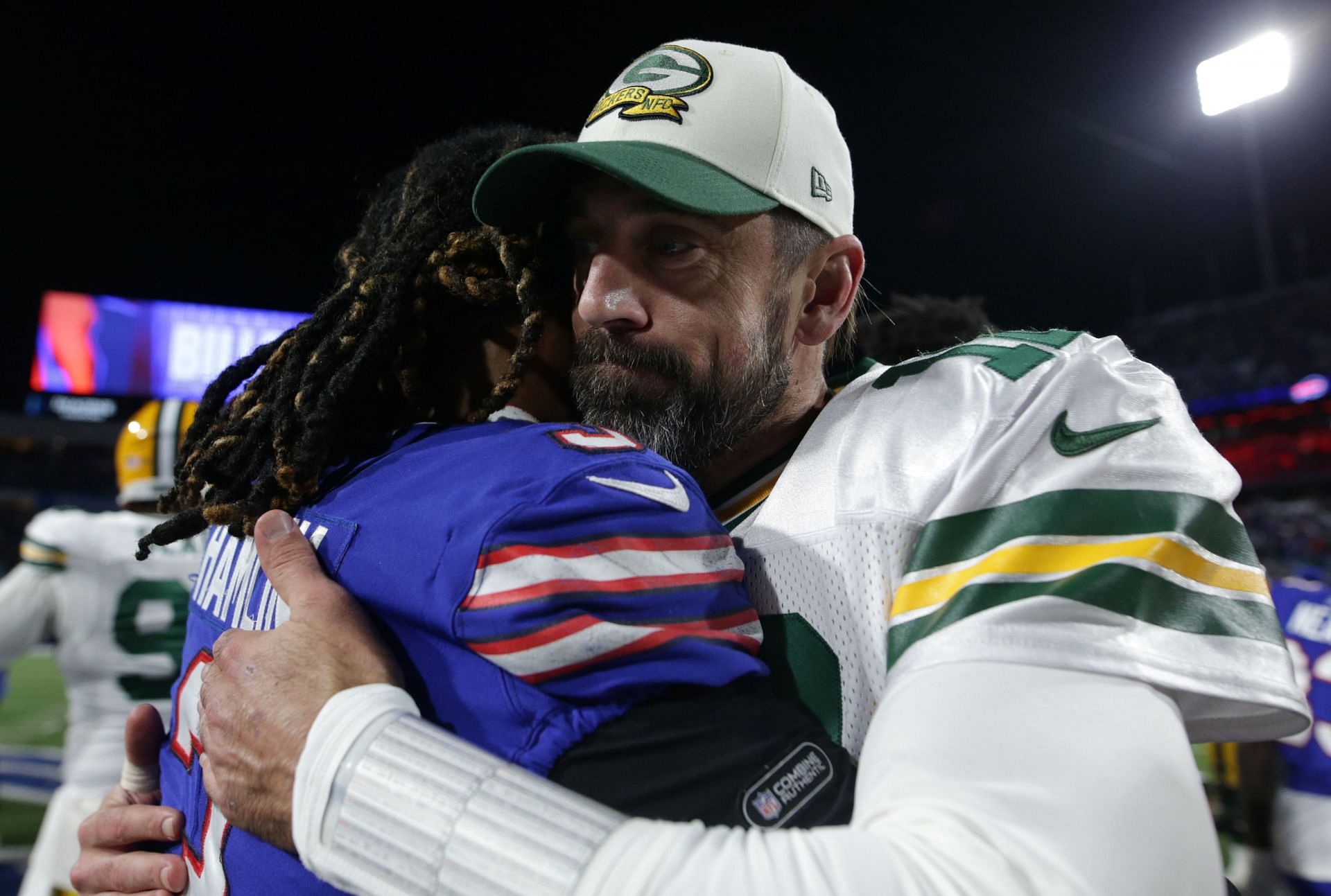 Aaron Rodgers of the Green Bay Packers (right) with Damar Hamlin of the Buffalo Bills