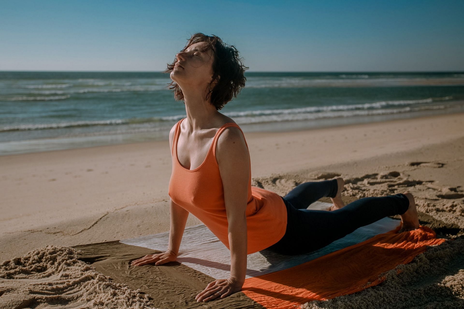 Daily yoga practice can help you feel energised throughtout the day. (Image via Unsplash / Julia Sakalouskaya)