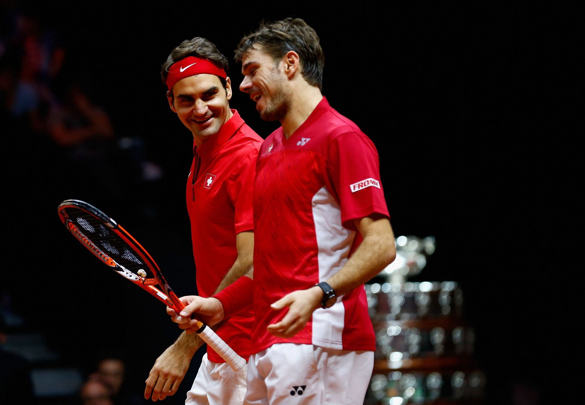 Roger Federer and Stan Wawrinka share a light moment during their doubles match at the Davis Cup Finals in 2014.