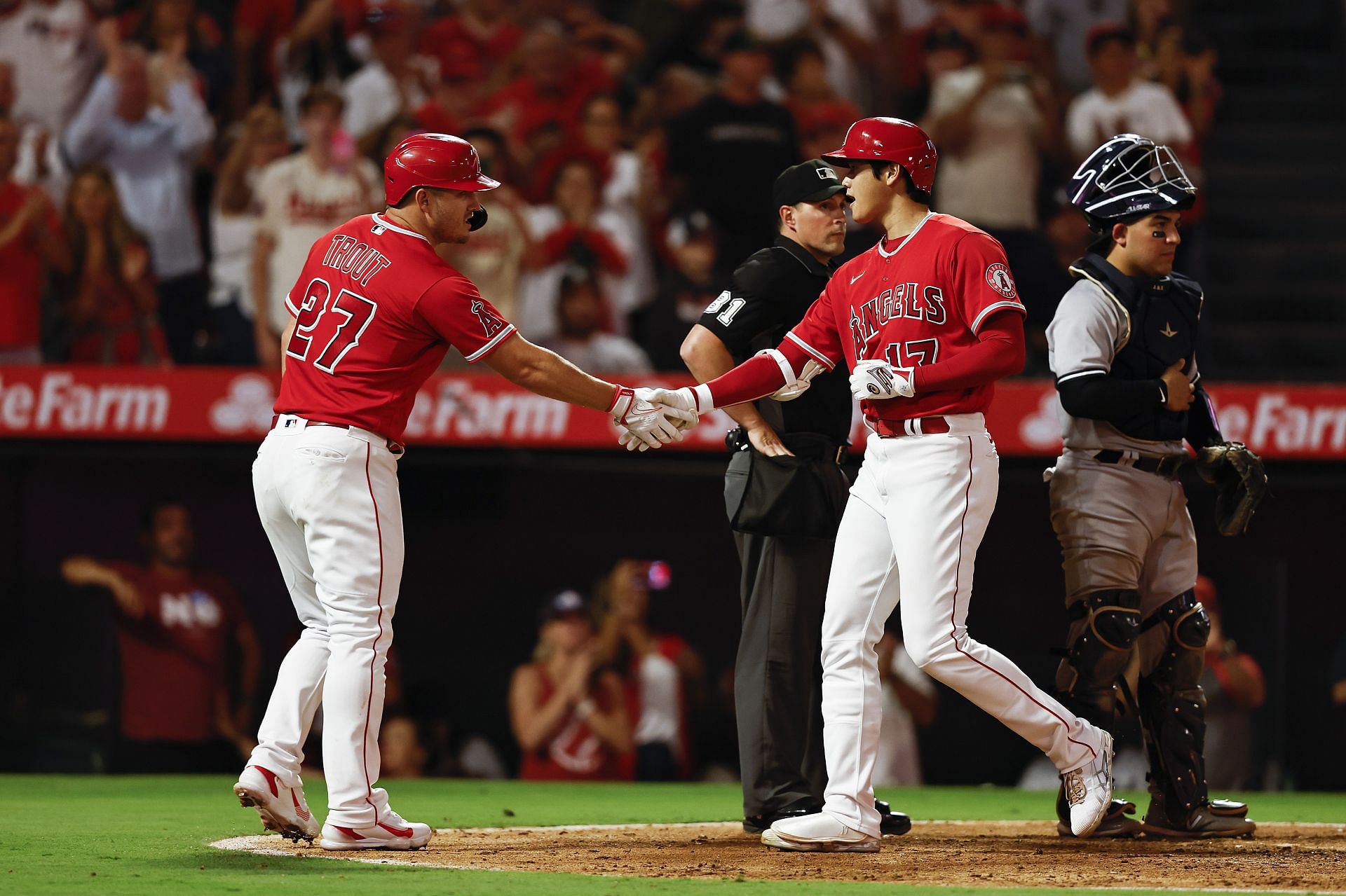 Shohei Ohtani celebrates with his teammate Mike Trout at Angel Stadium of Anaheim.