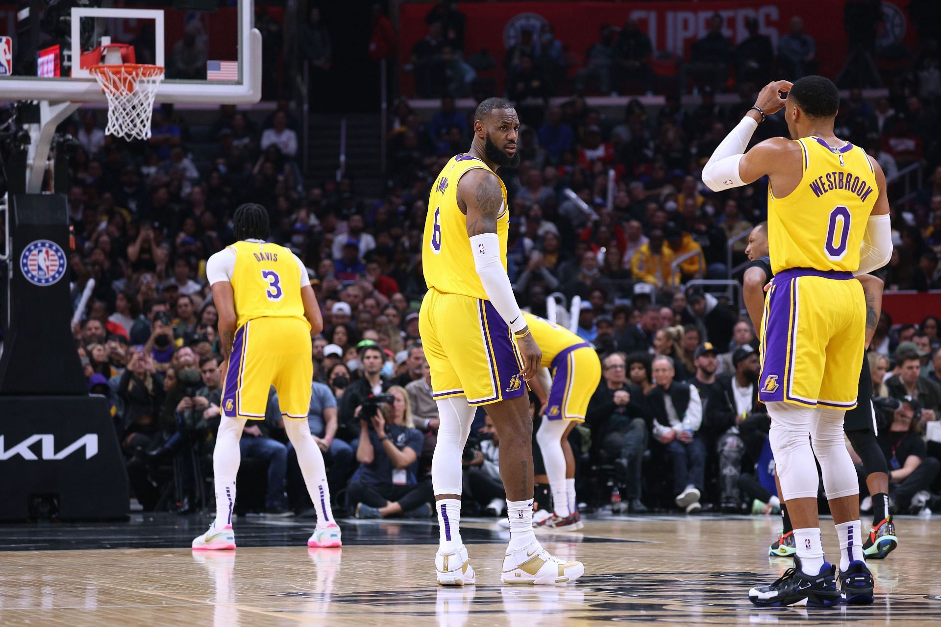 Anthony Davis of the LA Lakers shoots a free throw in front of LeBron James and Russell Westbrook.