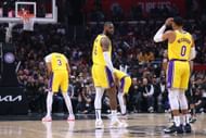 Anthony Davis of the LA Lakers shoots a free throw in front of LeBron James and Russell Westbrook.
