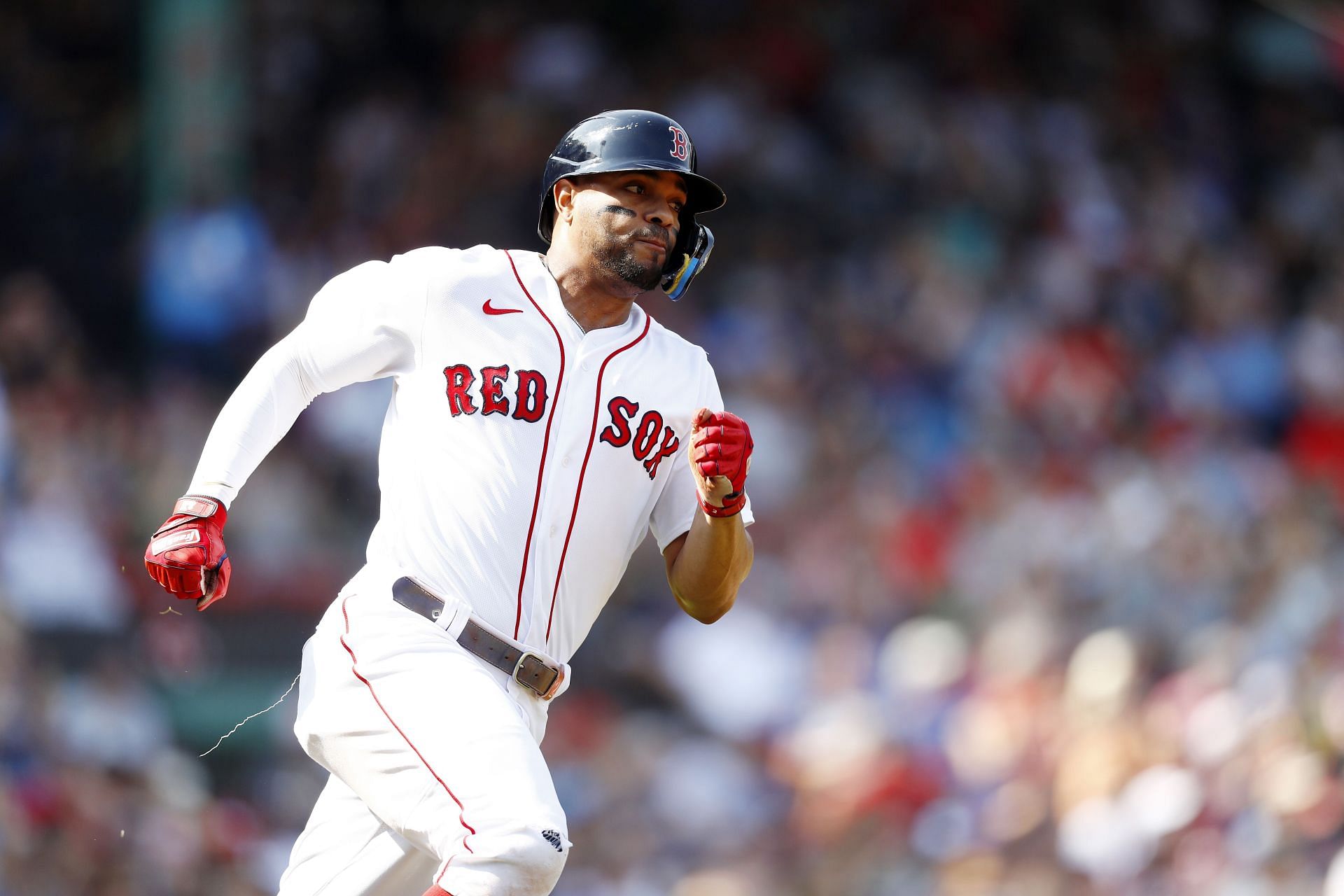 Xander Bogaerts rounds first base after hitting an RBI double in a game against the Kansas City Royals at Fenway Park