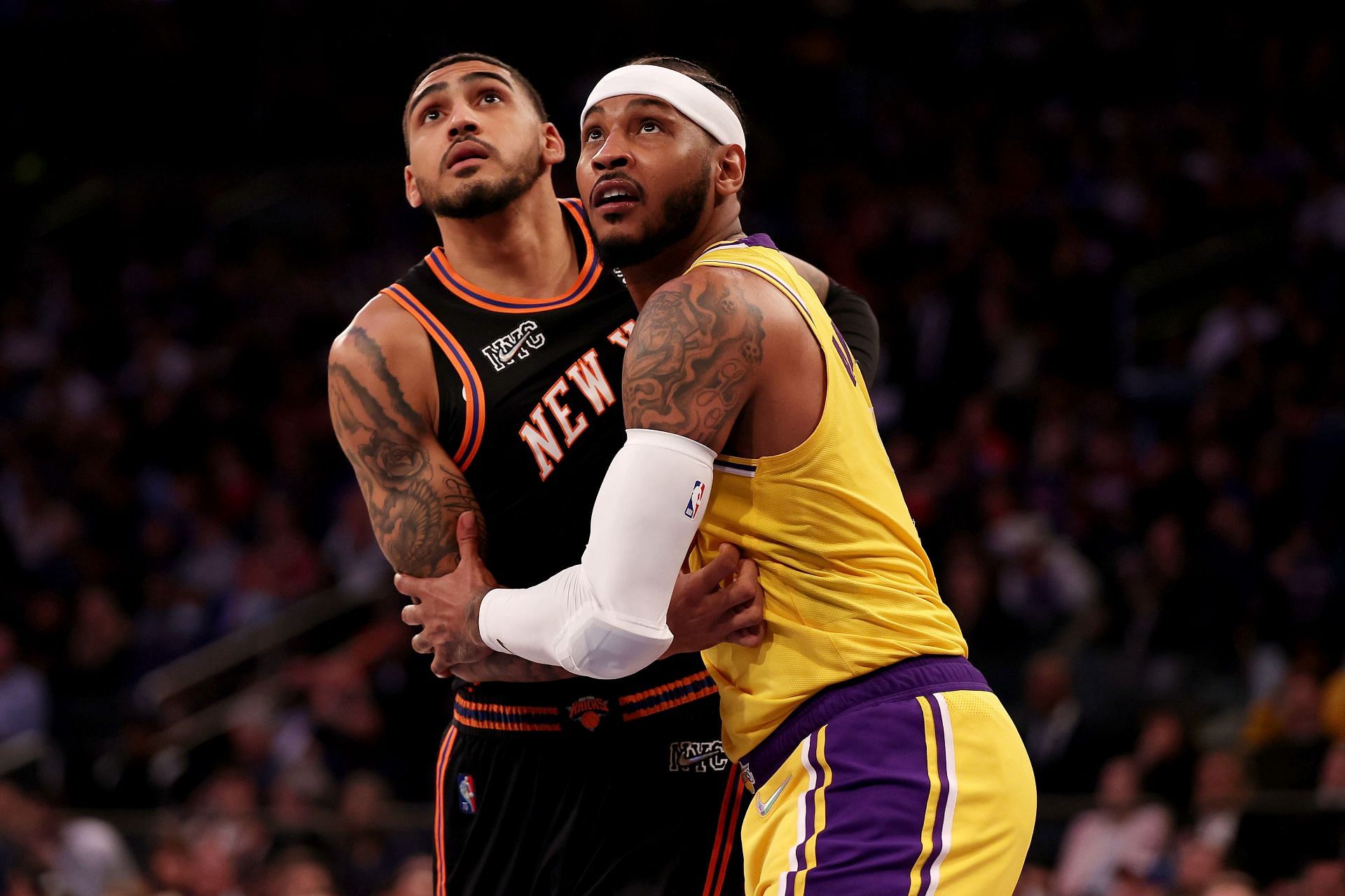 Carmelo Anthony competes for a rebound against Obi Toppin.