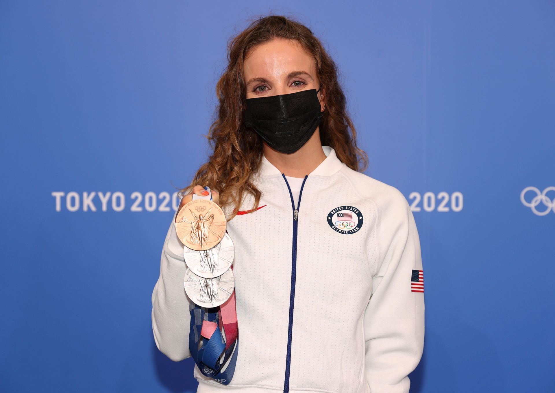 Smith poses with her three Olympic medals