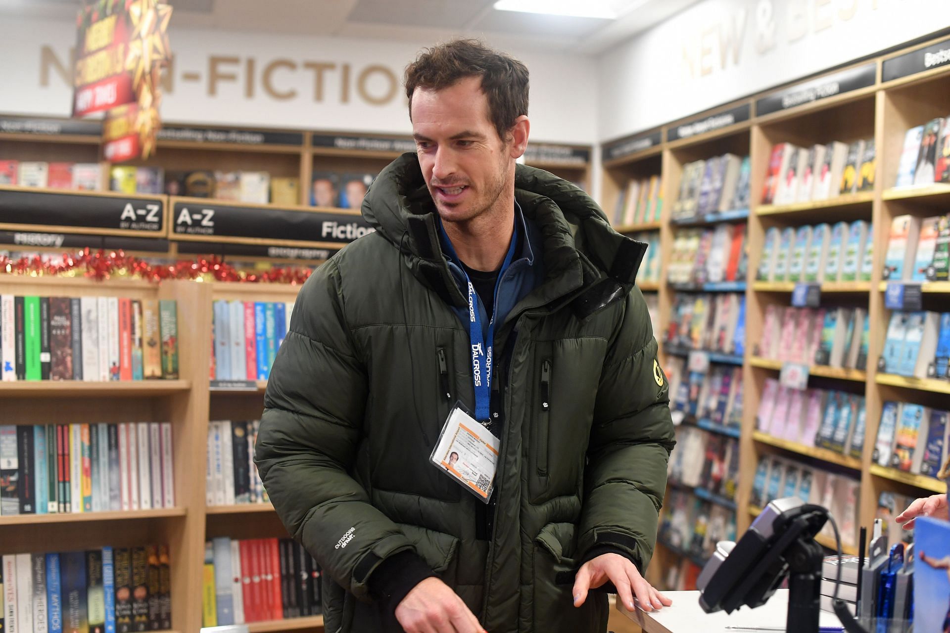 Andy Murray signs a copy of his book for a fan