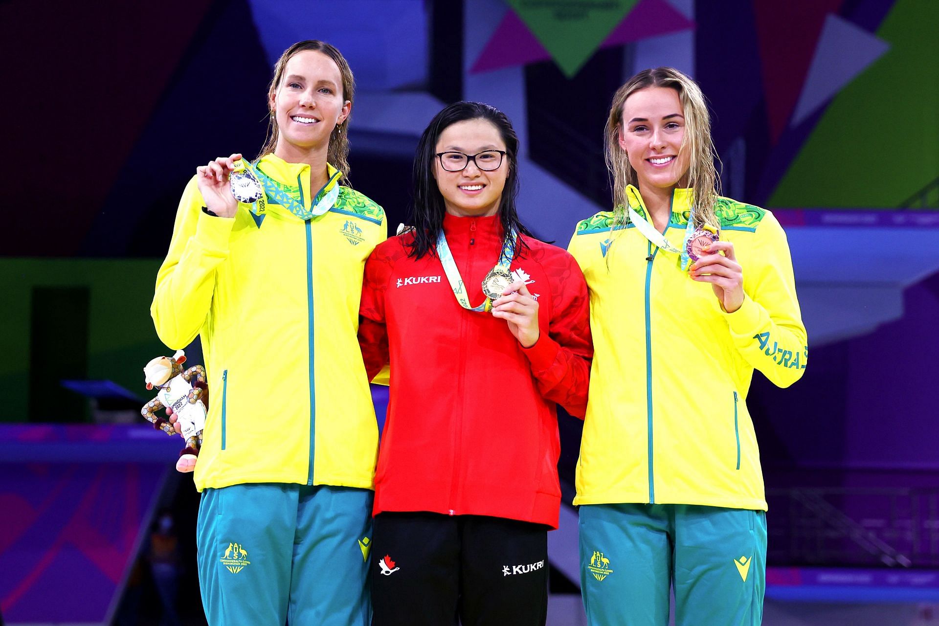 Silver medalist Emma McKeon, Gold medalist Margaret MacNeil of Team Canada, and Bronze medalist Brianna Throssell of Team Australia pose with their medals during the medal ceremony for the Women&#039;s 100m Butterfly Final on day two of the Birmingham 2022 Commonwealth Games