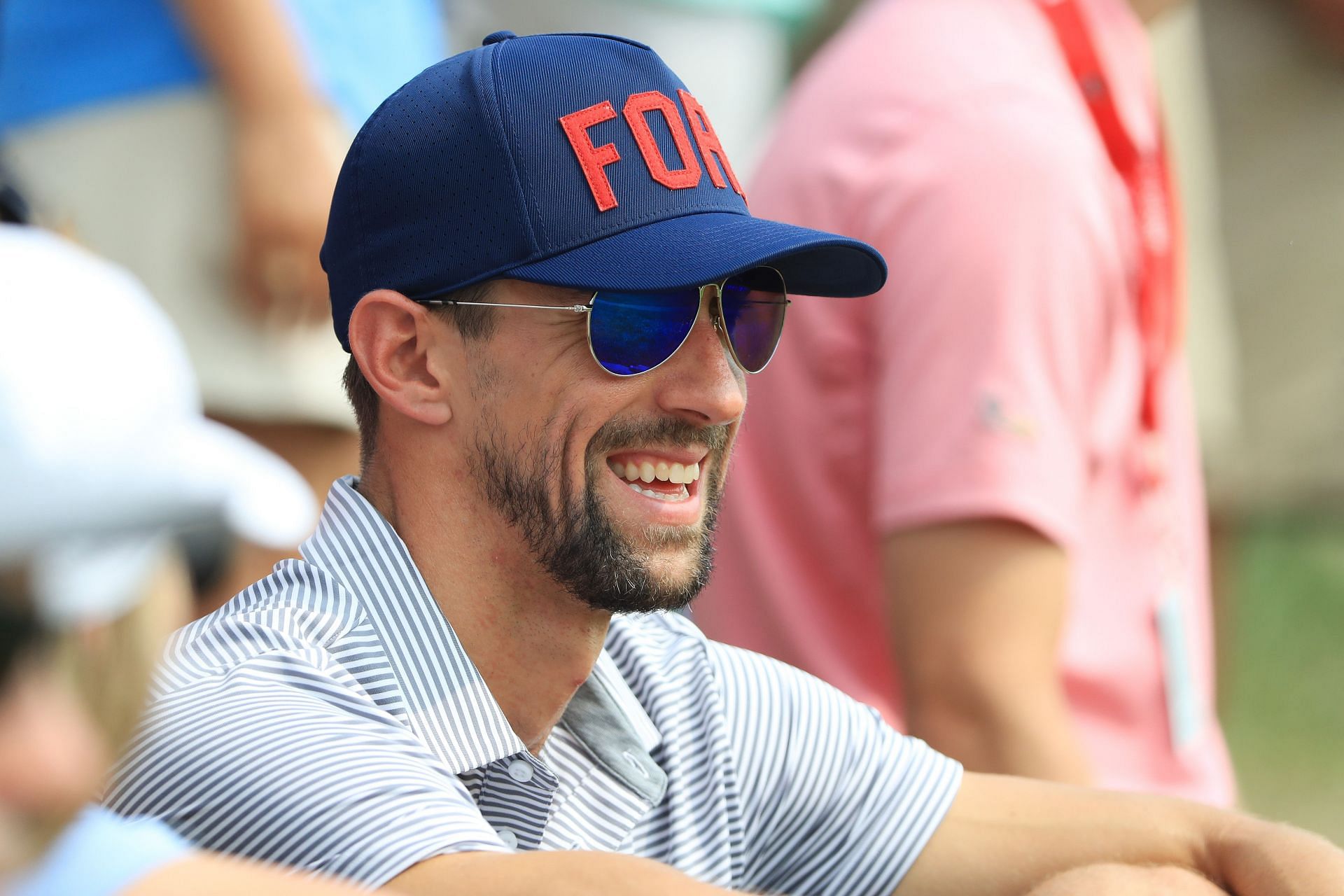 A smiling Michael Phelps spotted at the 2018 PGA Championship [Photo by Sam Greenwood/Getty Images]