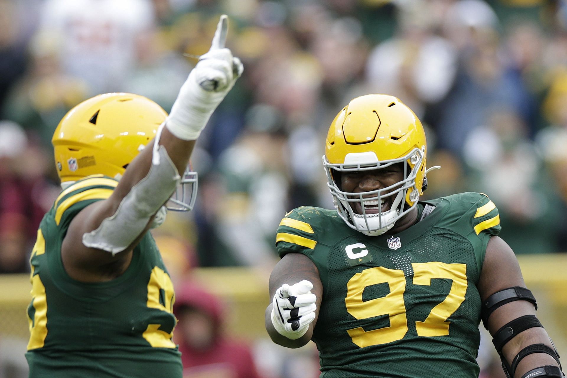 Kenny Clark celebrates with teammates after recording a sack in the fourth quarter against the Washington Football Team