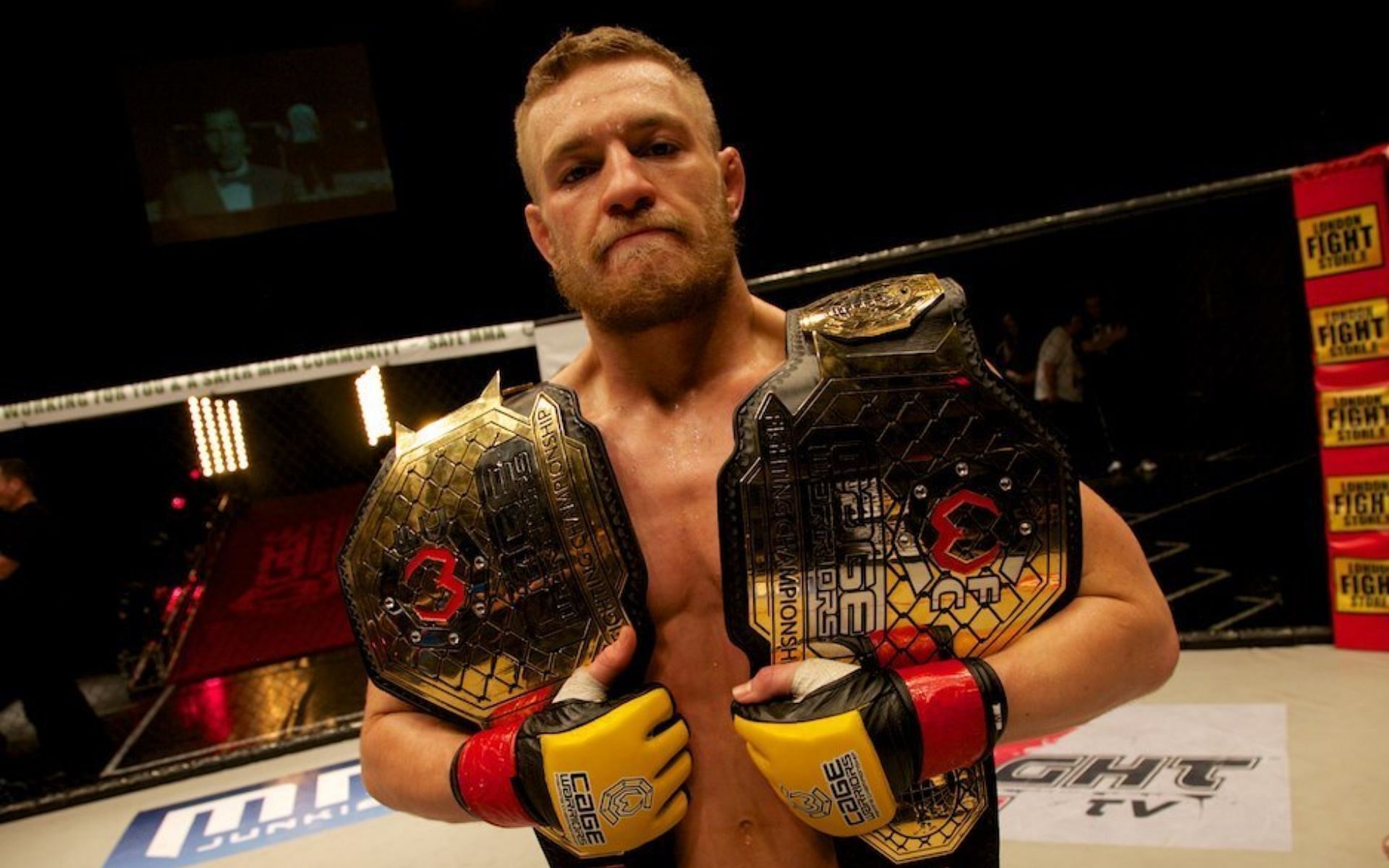 Conor McGregor as double champ at Cage Warriors. [via Cage Warriors]