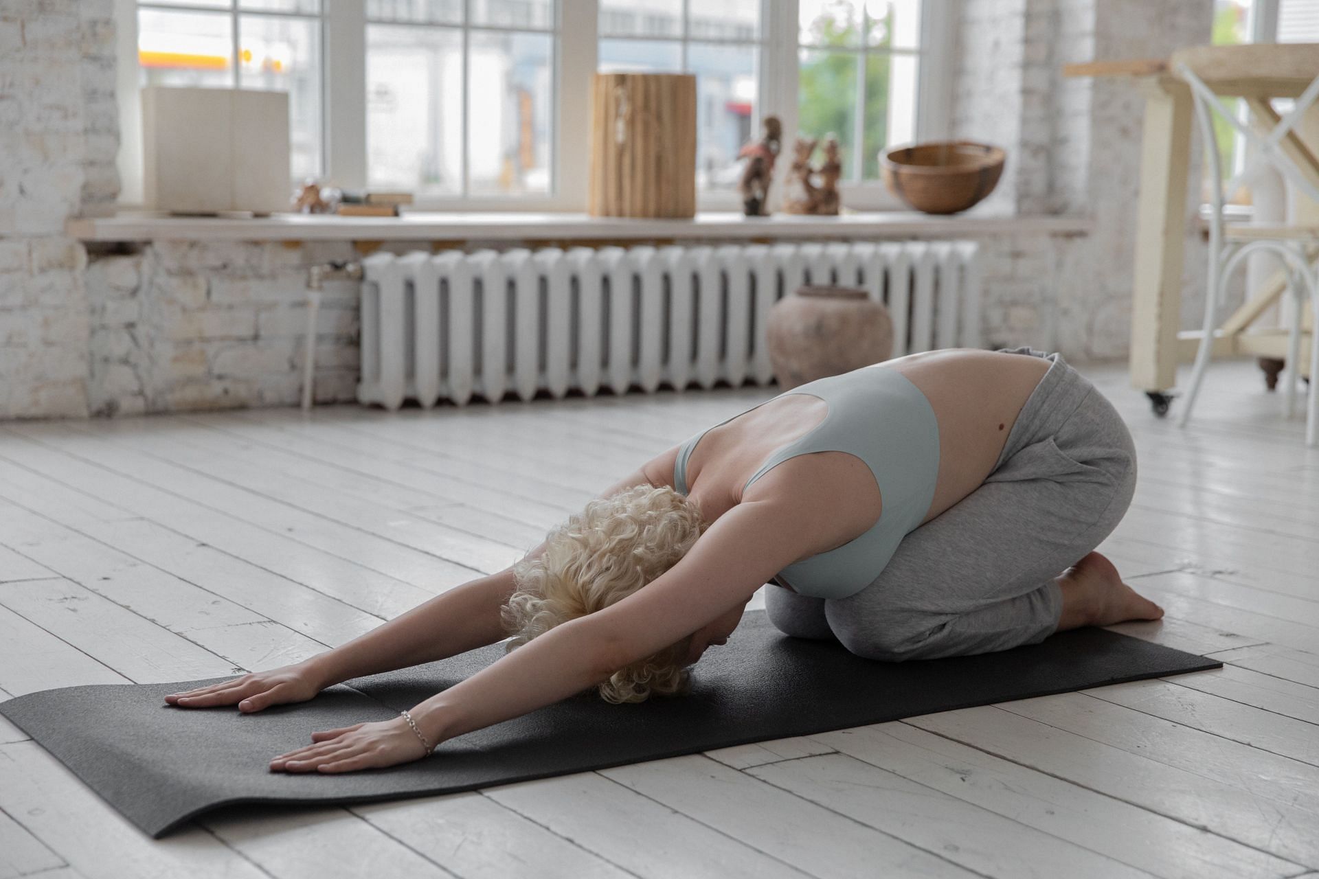 Relax in Balasana for a calming and grounding experience (Image via Pexels/Monstera)