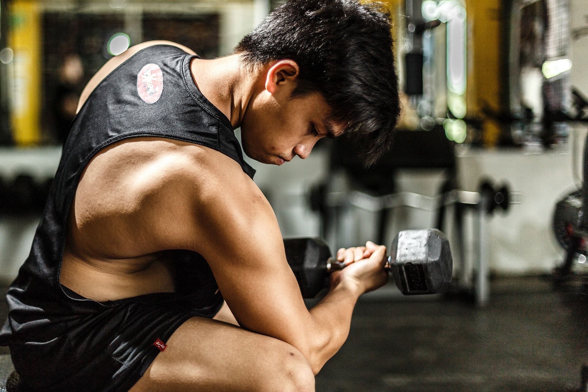 Bent-arm dumbbell row targets the biceps, triceps, shoulders, and lats. (Photo via Pexels/Timothy)