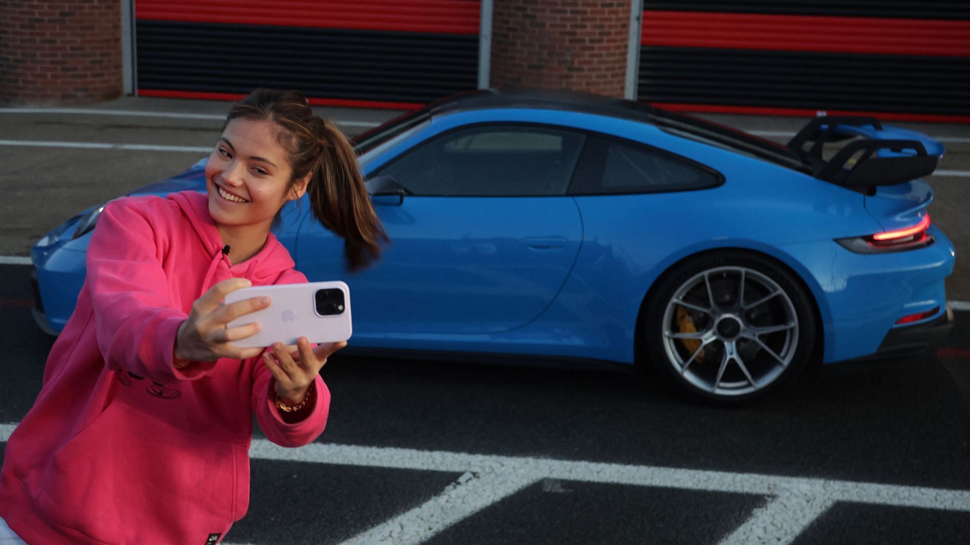 Emma Raducanu clicks a selfie with the Porsche 911 GT3