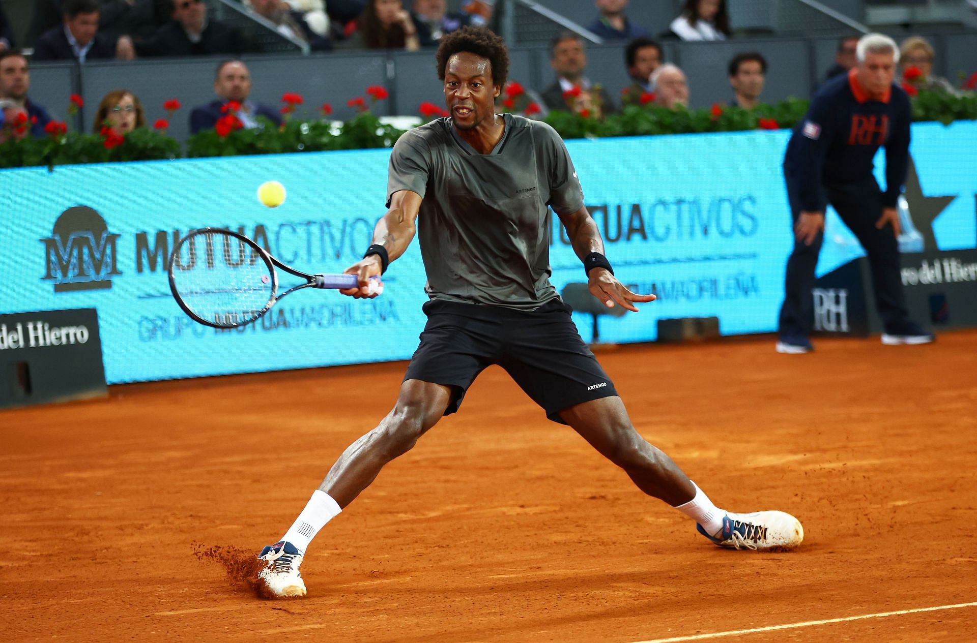 Gael Monfils slides as he plays a forehand during his second-round match against Novak Djokovic in Madrid.