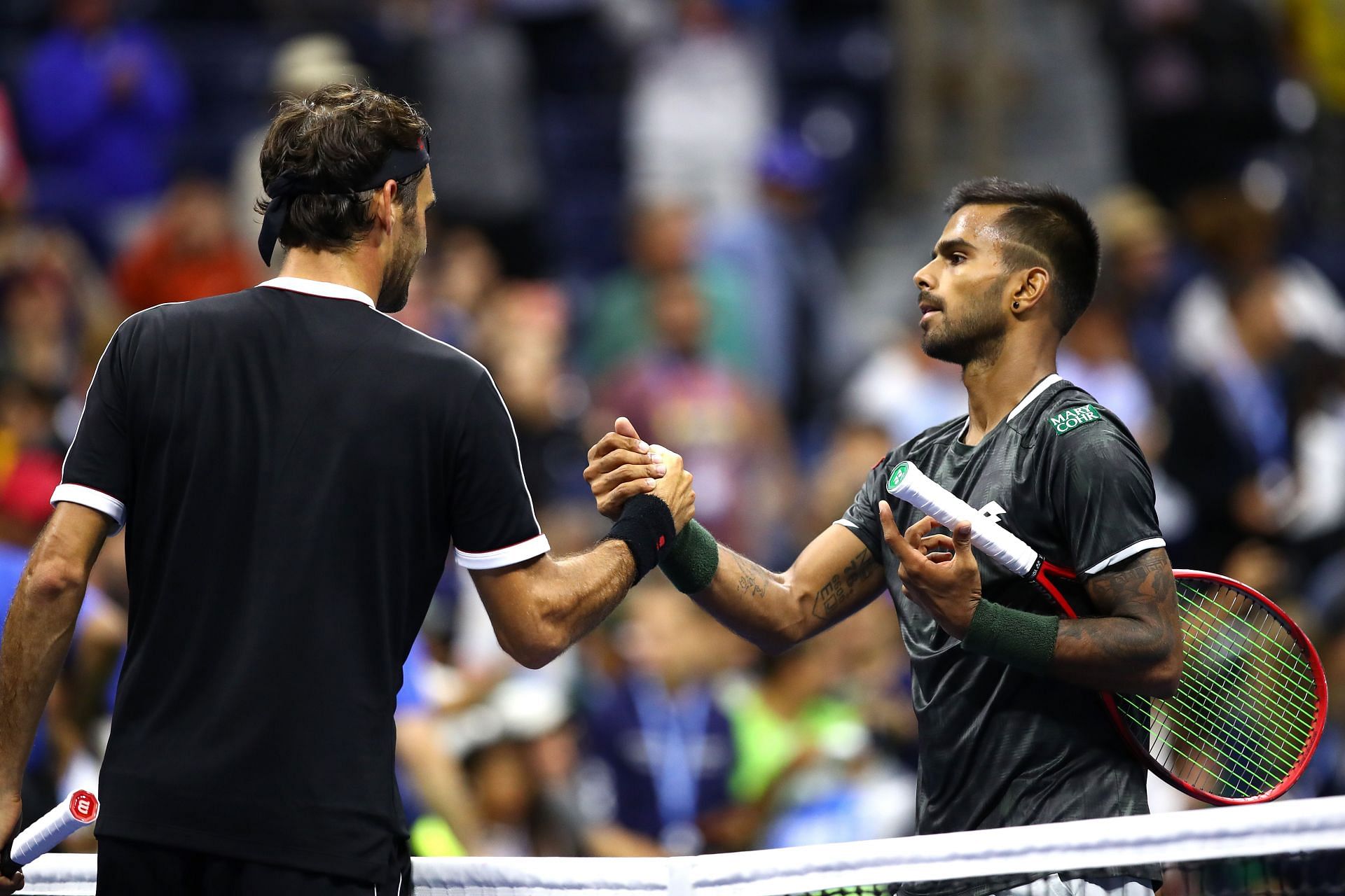 Sumit Nagal greets Roger Federer after their 2019 US Open match. 