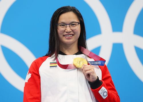 Margaret Macneil of Team Canada poses with the gold medal for the Women's 100m Butterfly Final on day three of the Tokyo 2020 Olympic Games.