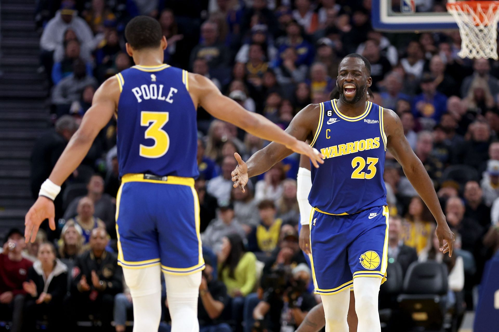 Jordan Poole (left) and Draymond Green of the Golden State Warriors