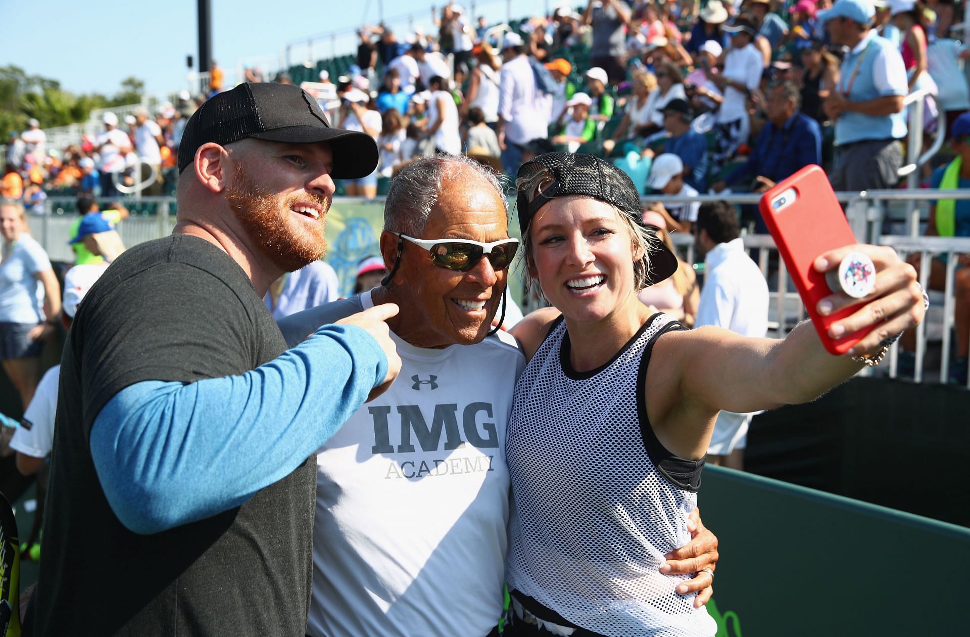 Bethanie Matek Sands takes a picture with Nick Bollettieri (center) at Miami Open 2018 - Day 2.