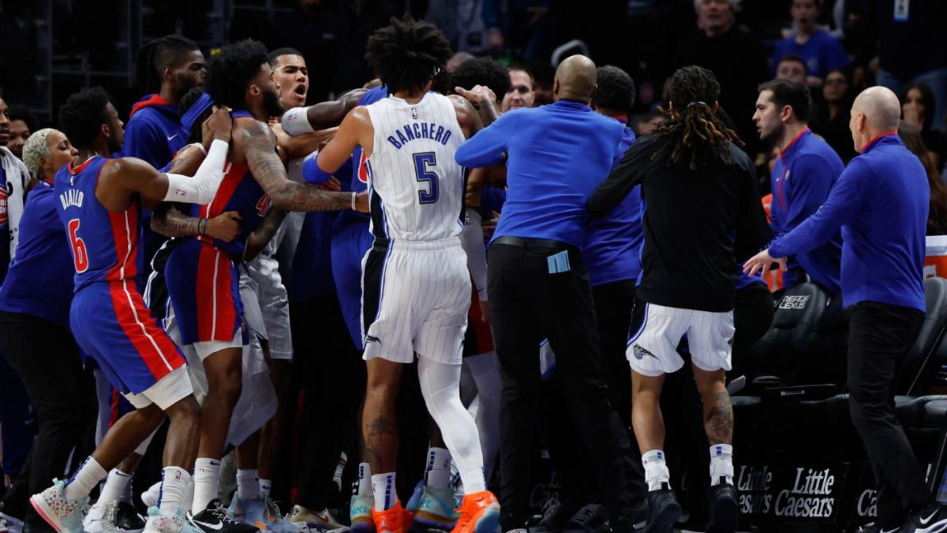 Magic and Pistons players gather around Killian Hayes and Moe Wagner