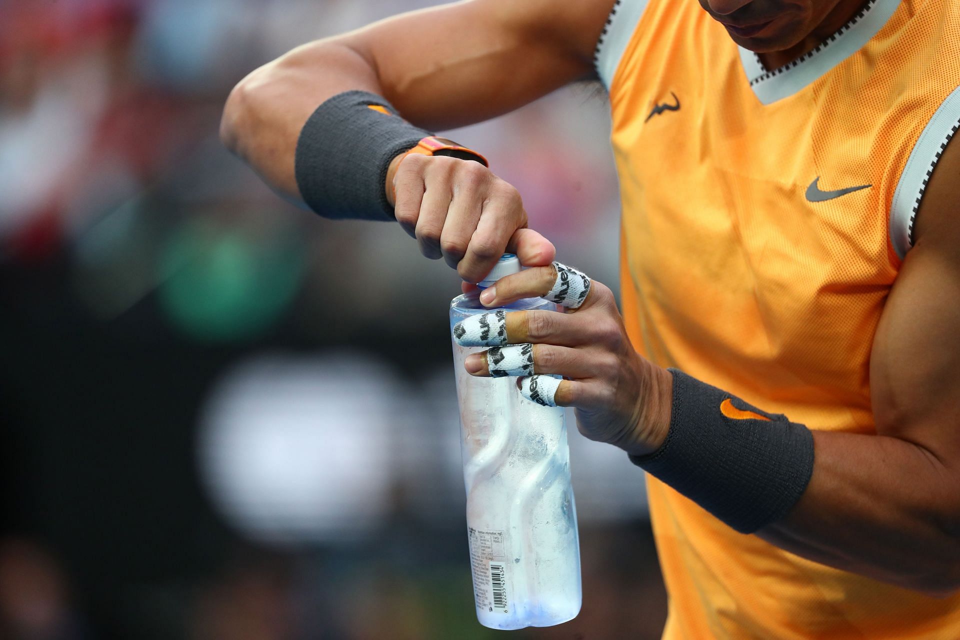 Rafael Nadal opening a bottle of water at the 2019 Australian Open