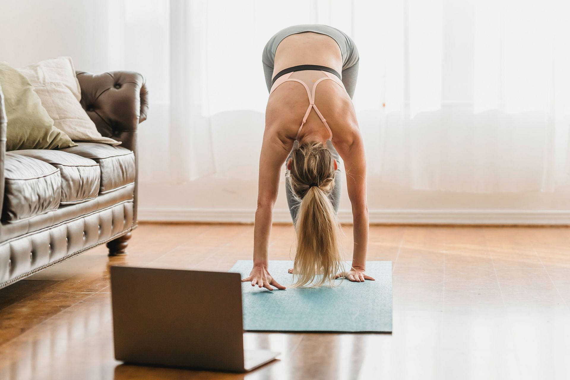 Uttanasana is one of the simplest yoga poses you can do to de-stress (Image via Pexels/Marta Wave)