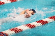 Thomas swims during the 400-yard freestyle relay at the Ivy League Women's Swimming and Diving Championships, 2022 (Photo by Kathryn Riley/Getty Images)