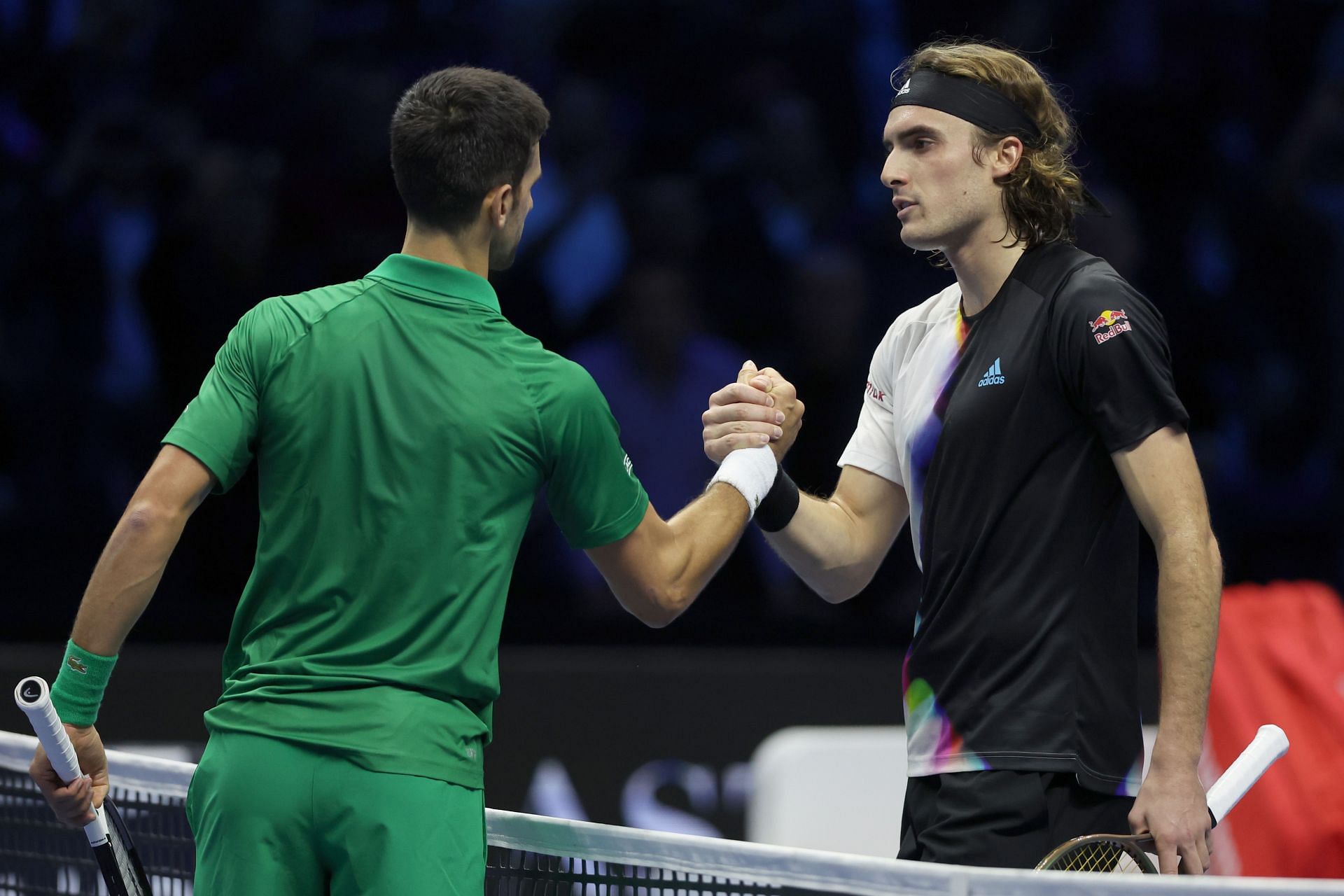 Novak Djokovic is congratulated at the net by Stefanos Tsitsipas