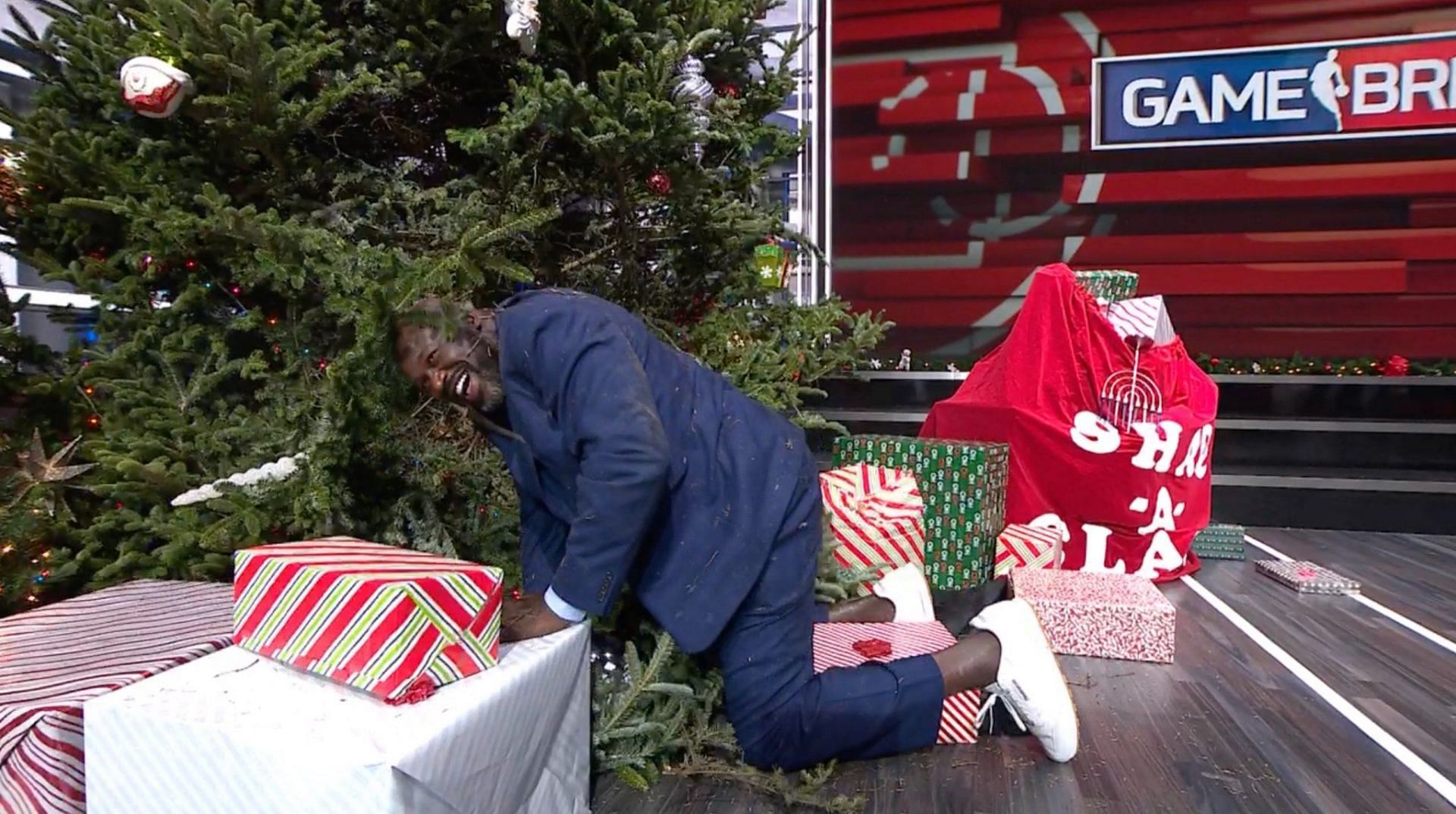 NBA legend-turned-TNT analyst Shaquille O&rsquo;Neal collecting himself after diving into a Christmas tree