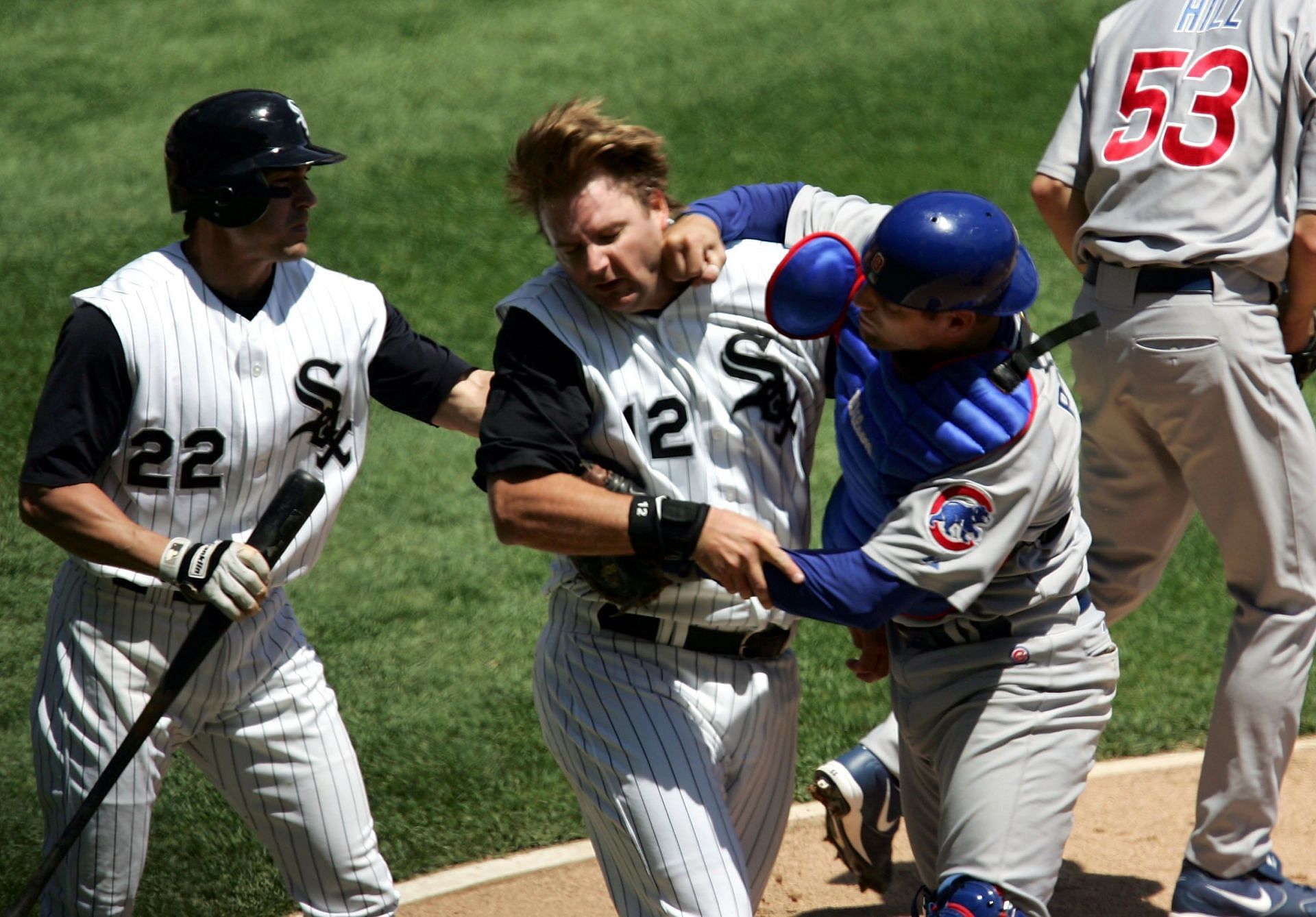 Michael Barrett #8 of the Chicago Cubs punches A.J. Pierzynski #12 of the Chicago White Sox
