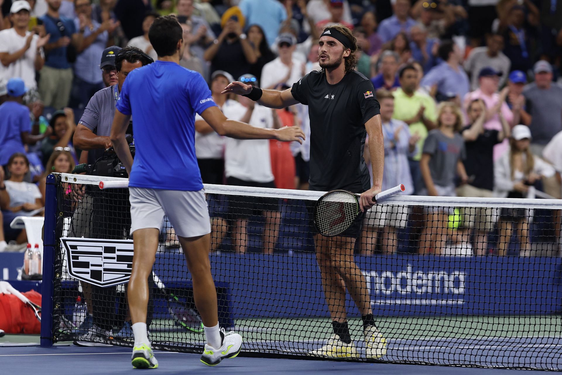 Stefanos Tsitsipas shakes hands with Daniel Elahi Galan after his defeat at the 2022 US Open
