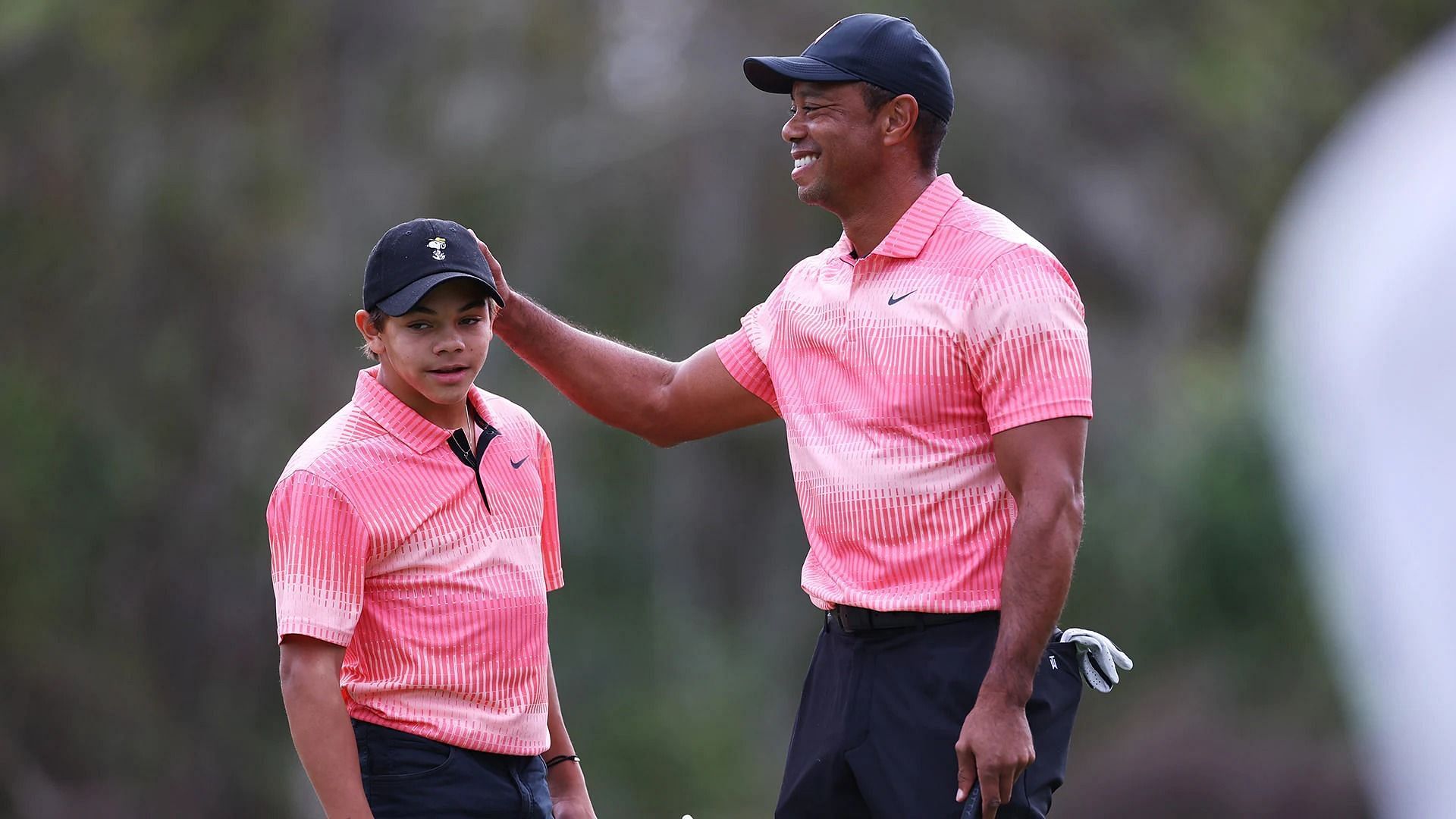 Charlie Woods with Tiger Woods during PNC Championships