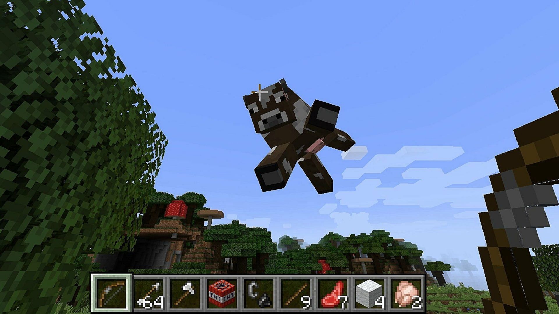 A cow is launched into the air in the Physics mod (Image via Mojang)