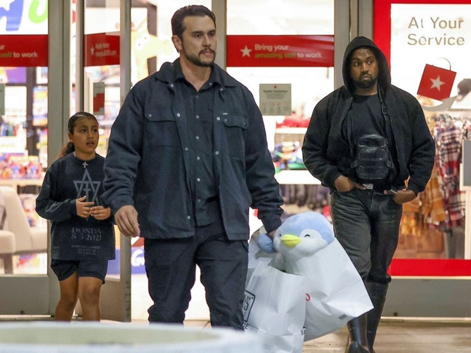 Kanye West shopping with his daughter, North West (Image via Backgrid)