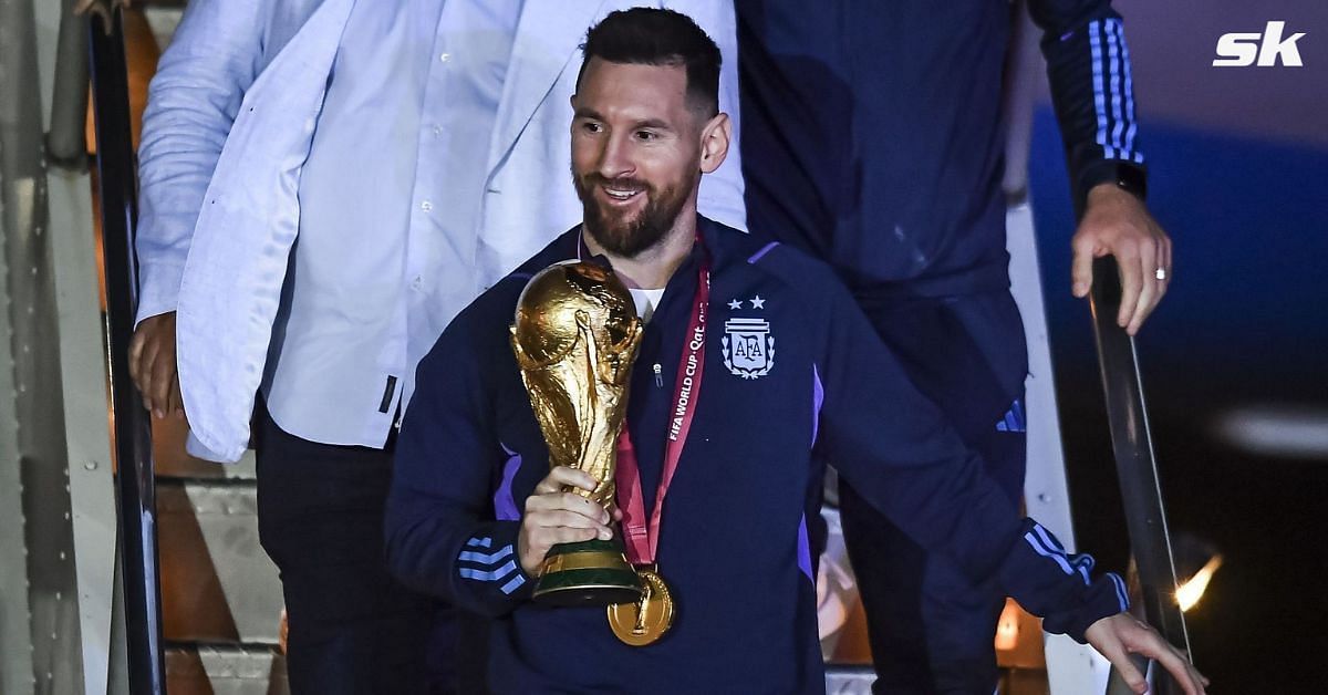 Lionel Messi with the FIFA World Cup trophy. 