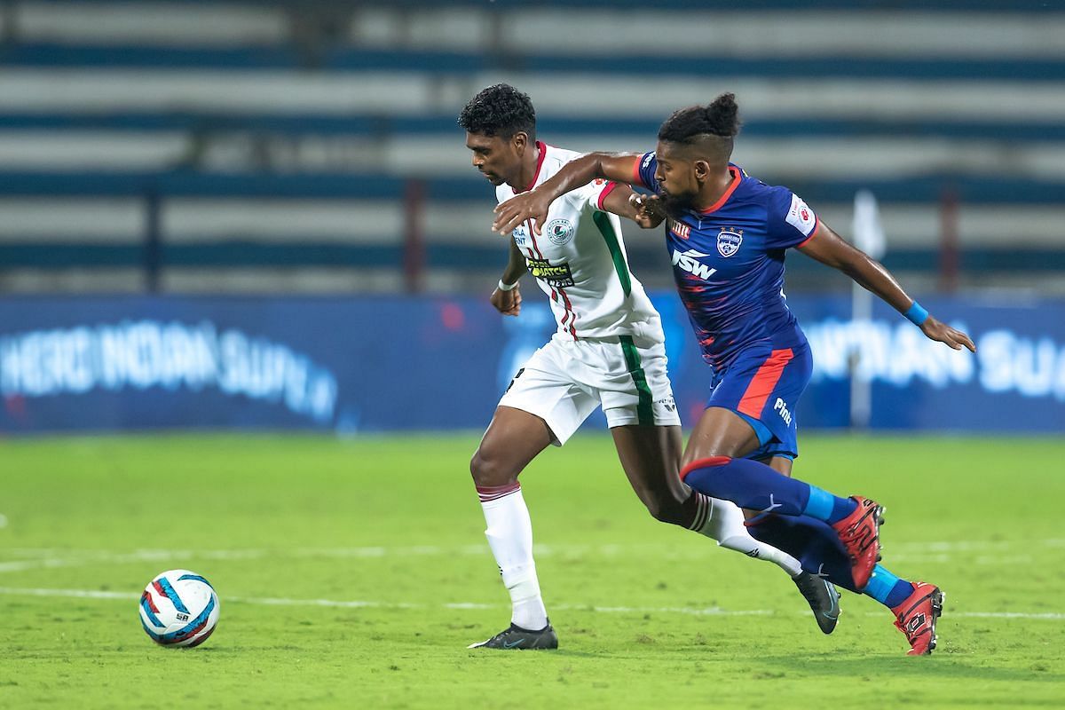 Roy Krishna tussling for the ball with Liston Colaco during BFC