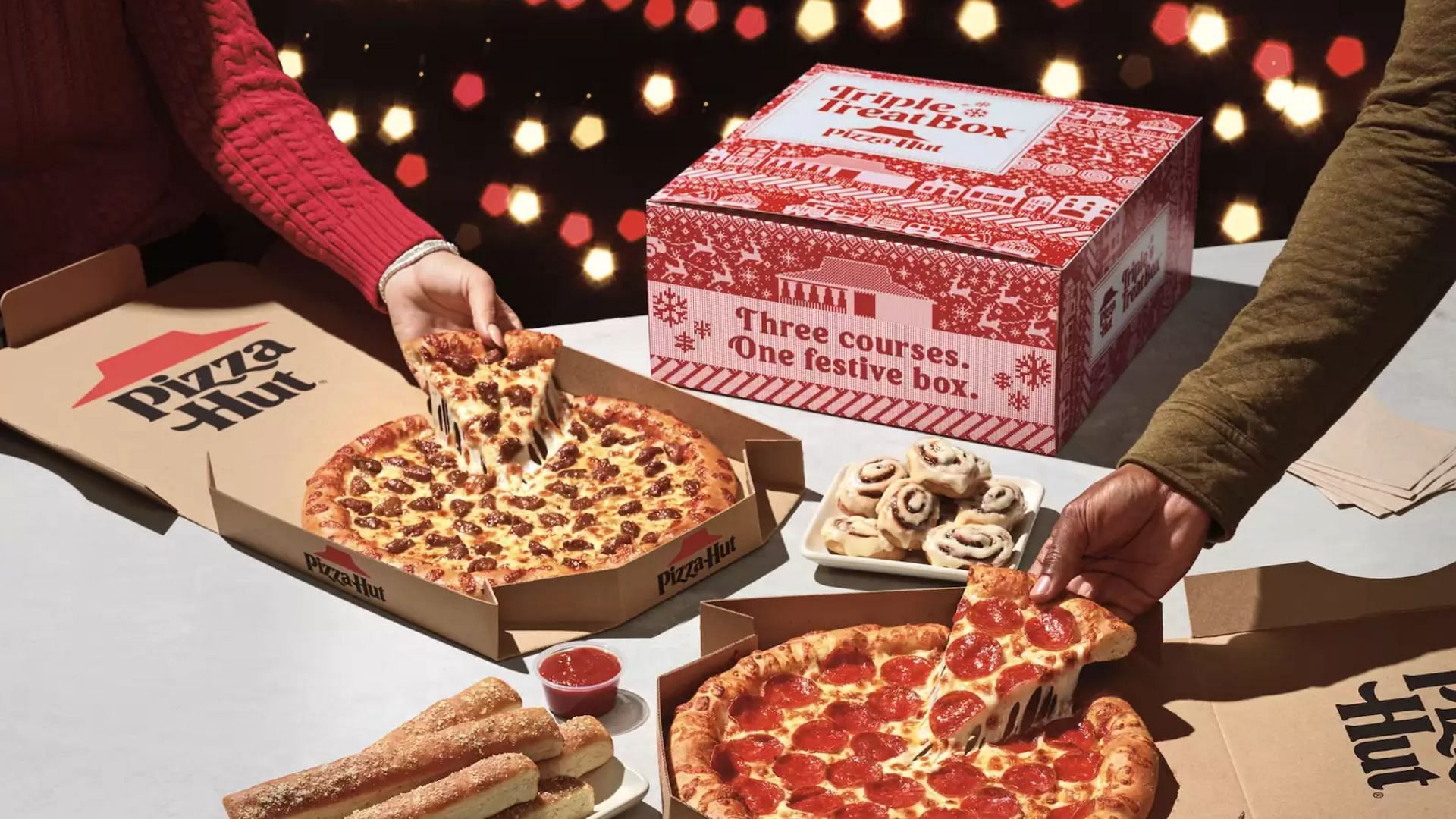 The Triple Treat Box with two medium pizzas, five breadsticks, and ten Cinnabon Mini Rolls (Image via Pizza Hut)